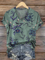 Soft cotton women’s t-shirt in deep forest green with ditsy floral pattern, featuring a relaxed fit and retro vibe